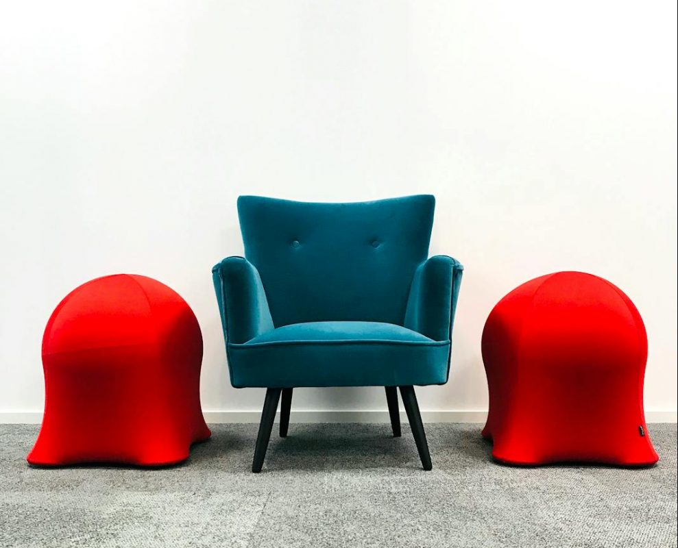 a blue armchair on the carpet