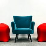 a blue armchair on the carpet