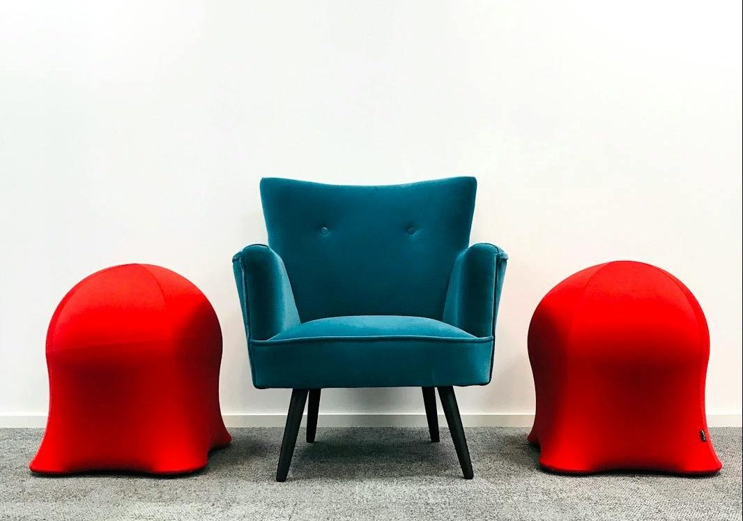 a blue armchair on the carpet